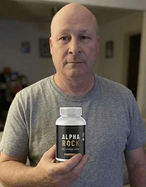 Man at home holding a bottle of AlphaRock